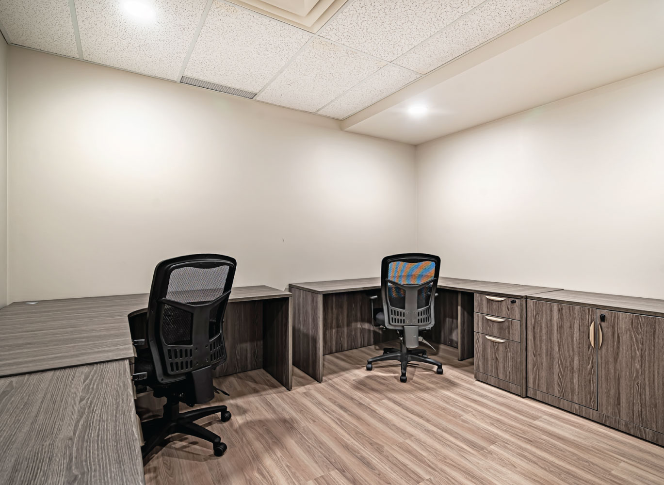 Shared office space with ergonomic seating and modern built-in desks